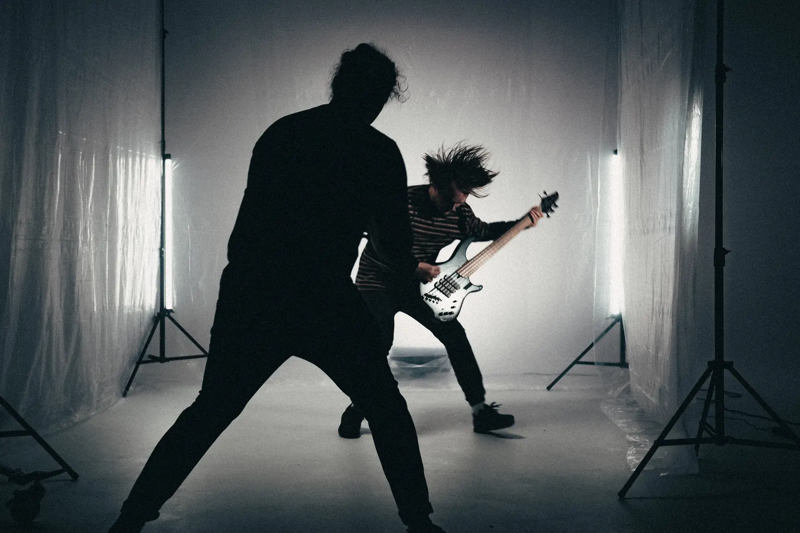 Behind-the-scenes photo of a guitarist in a studio performance setup.