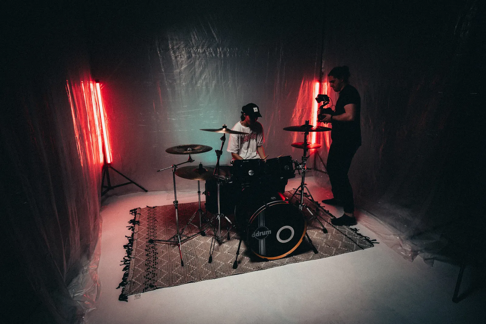 Behind-the-scenes photo of a music video studio setup with red practical lighting.