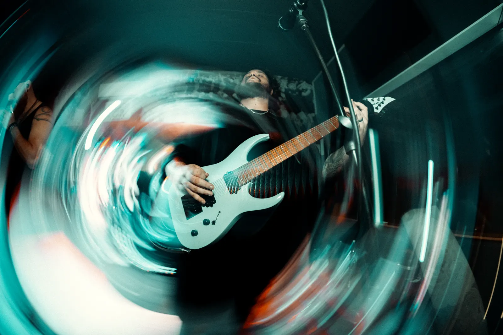 Live music photo of a guitarist with radial motion blur.